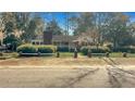 Traditional brick home featuring a quaint front porch and well-maintained yard with a brick and post fence at 409 Dowling Ave, Walterboro, SC 29488