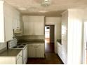 Functional kitchen with white cabinets, plenty of countertop space, and matching appliances at 411 Maplewood Dr, Walterboro, SC 29488