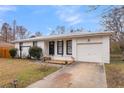 Cozy one-story home with a white brick facade, black-framed windows and a single-car garage at 4437 Logwood Dr, Ladson, SC 29456