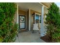 Inviting front porch featuring a cozy chair, stylish decor, and the home's address at 5037 Govan Rd, Hollywood, SC 29449