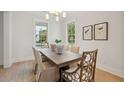 Elegant dining room with a wooden table, stylish chairs, and ample natural light from large windows at 5742 Kiawah River Dr, Johns Island, SC 29455