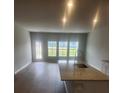 Bright and airy kitchen featuring an island, granite countertops, stainless sink, and natural light from large windows at 598 Red Monarch Way, Moncks Corner, SC 29461