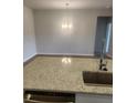 View of kitchen island with granite countertops, stainless steel sink and chandelier over dining area at 598 Red Monarch Way, Moncks Corner, SC 29461