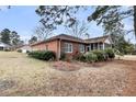 Expansive backyard with a brick home featuring a screened porch and lush green lawn at 101 S Gateshead Crossing, Goose Creek, SC 29445
