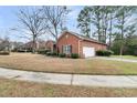Detached brick garage with an automatic door, surrounded by a well-kept yard and landscaping at 101 S Gateshead Crossing, Goose Creek, SC 29445