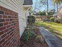 This is the side yard, featuring a brick foundation, vinyl siding, and a sidewalk at 110 Greyson Cir, Goose Creek, SC 29445