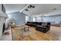 Bright living room features hardwood floors, a brick fireplace, a comfortable sectional, and natural light at 1228 Brookside Dr, Hanahan, SC 29410