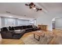 Spacious living room with a large sectional sofa, hardwood floors, and stylish ceiling fan at 1228 Brookside Dr, Hanahan, SC 29410