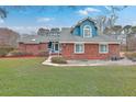 Inviting brick home with a well-maintained lawn and a quaint, blue-accented entrance at 131 Londonderry Rd, Goose Creek, SC 29445