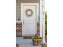 Close-up of the front door with a decorative wreath and seasonal flowers at 1413 Tannery, Johns Island, SC 29455