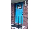 Close up of a vibrant blue front door with a window detail and classic brick surround at 1418 Kentwood Circle Cir, Charleston, SC 29412