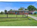 Charming brick home featuring a well-maintained lawn, vibrant blue door, and matching shutters at 1418 Kentwood Circle Cir, Charleston, SC 29412