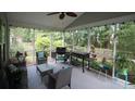 Relaxing screened porch with comfortable seating and an outdoor kitchen area at 1481 Clarendon Way, Mount Pleasant, SC 29466