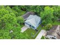 Aerial view of blue home with well-manicured lawn and mature trees, blending seamlessly with the neighborhood at 1565 Juniper St, Charleston, SC 29407
