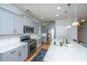 Modern kitchen boasts stainless steel appliances, island, and gray cabinets at 1610 Mermentau St, Mount Pleasant, SC 29466