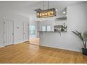 Open kitchen area featuring modern lighting, stainless steel appliances, and breakfast bar at 1747 Towne St, Johns Island, SC 29455
