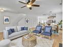 Bright living room featuring hardwood floors, a ceiling fan, and stylish furniture at 1747 Towne St, Johns Island, SC 29455