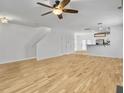 Spacious living room boasts hardwood floors, a staircase, and access to other rooms at 1747 Towne St, Johns Island, SC 29455