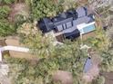 Aerial view showcasing the home's layout, pool, and surrounding wooded landscape at 215 Fell Pt, Daniel Island, SC 29492