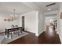 Elegant dining room with hardwood floors, decorative light fixture, and views into the living room at 219 Seaworthy St, Summerville, SC 29486