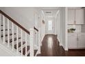 Bright entryway featuring hardwood floors, stairs with wood handrail, and decorative lighting at 219 Seaworthy St, Summerville, SC 29486