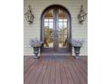 Elegant arched front door with glass panels and decorative planters at 2217 Beckenham Dr, Mount Pleasant, SC 29466