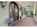 Covered porch features seating area with ceiling fan and stylish decor at 2217 Beckenham Dr, Mount Pleasant, SC 29466