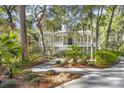 A charming home with a welcoming front porch and a beautifully landscaped yard at 2824 Old Drake Dr, Seabrook Island, SC 29455