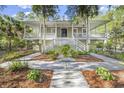 A picturesque home with an inviting porch and a well-manicured front yard at 2824 Old Drake Dr, Seabrook Island, SC 29455