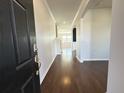 View of the entryway showcasing hardwood floors and neutral walls leading into the home's living spaces at 3072 Adventure Way, Ladson, SC 29456