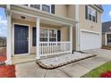 Inviting front porch with white railing and decorative stone accents, leading to a dark front door at 315 Bradley Bend Dr, Moncks Corner, SC 29461