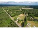 Sprawling aerial view showing the vast wooded acreage and rural setting of the property at 3657 Santee River Rd, Saint Stephen, SC 29479