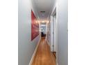 Hallway leading to living room with hardwood floors and neutral paint, creating a warm and inviting atmosphere at 40 Bee Street # 314, Charleston, SC 29403