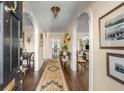 Elegant foyer with hardwood floors, arched doorways, and classic decor at 40 New St, Charleston, SC 29401