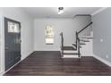 Entryway with hardwood floors, staircase, decorative door and trim, and neutral walls at 405 Simmons Ave, Summerville, SC 29483