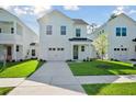Charming two-story home with a one car garage, framed by green lawn and neighboring homes at 420 Queen View Ln, Charleston, SC 29414