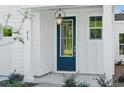 A stylish front door with glass panels and a vintage-inspired lantern hanging above at 420 Queen View Ln, Charleston, SC 29414