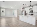 Open concept kitchen with white cabinets and stainless appliances at 422 Queenview Ln, Charleston, SC 29414