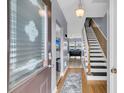 Bright foyer featuring hardwood floors, staircase and views into the living spaces at 4791 Arco Ln, North Charleston, SC 29418