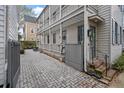 Charming home featuring a quaint courtyard, classic columns, and neutral color palette at 54 Warren St, Charleston, SC 29403