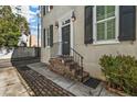 Close up of the home's front door with elegant brick steps at 7 West St # C, Charleston, SC 29401