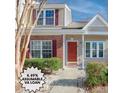 Charming townhouse featuring brick accents, red shutters, and a well-manicured front lawn at 7900 Shadow Oak Dr Dr, North Charleston, SC 29406