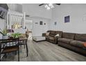 Open-concept space featuring laminate flooring, a vaulted ceiling, and easy access to other rooms at 7900 Shadow Oak Dr Dr, North Charleston, SC 29406