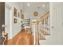 Bright foyer with hardwood floors, staircase, and a view into the living area at 8656 Laurel Grove Ln, North Charleston, SC 29420