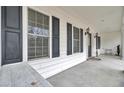 Inviting front porch with a seating area and view of the front yard at 8656 Laurel Grove Ln, North Charleston, SC 29420