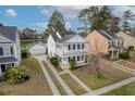 Inviting home with a double balcony and a detached garage, nestled by a tranquil lake at 8957 N Red Maple Cir, Summerville, SC 29485