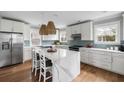 Bright kitchen with white cabinets, stainless steel appliances, and a center island with marble countertop at 972 Key Colony Ct, Mount Pleasant, SC 29464