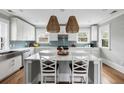 Bright kitchen with white cabinets, stainless steel appliances, and a center island with marble countertop at 972 Key Colony Ct, Mount Pleasant, SC 29464