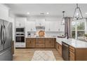 Modern kitchen with stainless steel appliances, large island, and hardwood floors at 106 Abbey Terrace Rd, Moncks Corner, SC 29461