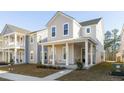 Charming two-story home featuring a welcoming front porch with classic columns and a well-manicured lawn at 109 Osprey Ridge Ln, Summerville, SC 29483